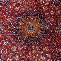Persian Kashan wool carpet, red field centred with large floral medallion and conforming pendants, decorated with scrolling foliage and flowerheads, indigo spandrels and borders, from the region of Kashan