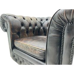 Chesterfield armchair, upholstered in distressed brown buttoned back leather