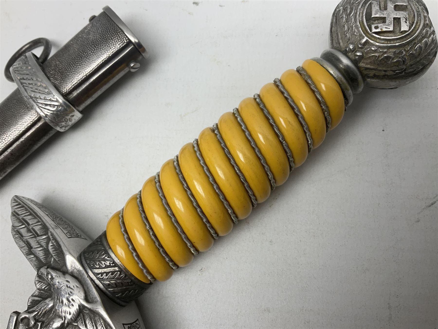 WW2 German Luftwaffe 2nd Pattern Officers dress dagger, with unmarked 25.5cm double edged steel blade, wire-bound pale orange/yellow celluloid grip, globular  pommel with oak leaves and traces of gilding, Luftwaffe eagle cross guard; in beaded scabbard with two suspension rings L43cm overall