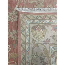 Persian Zeigler design rug, peach ground decorated with trailing branches and stylised plant motifs, the guarded border decorated with further plant moitfs