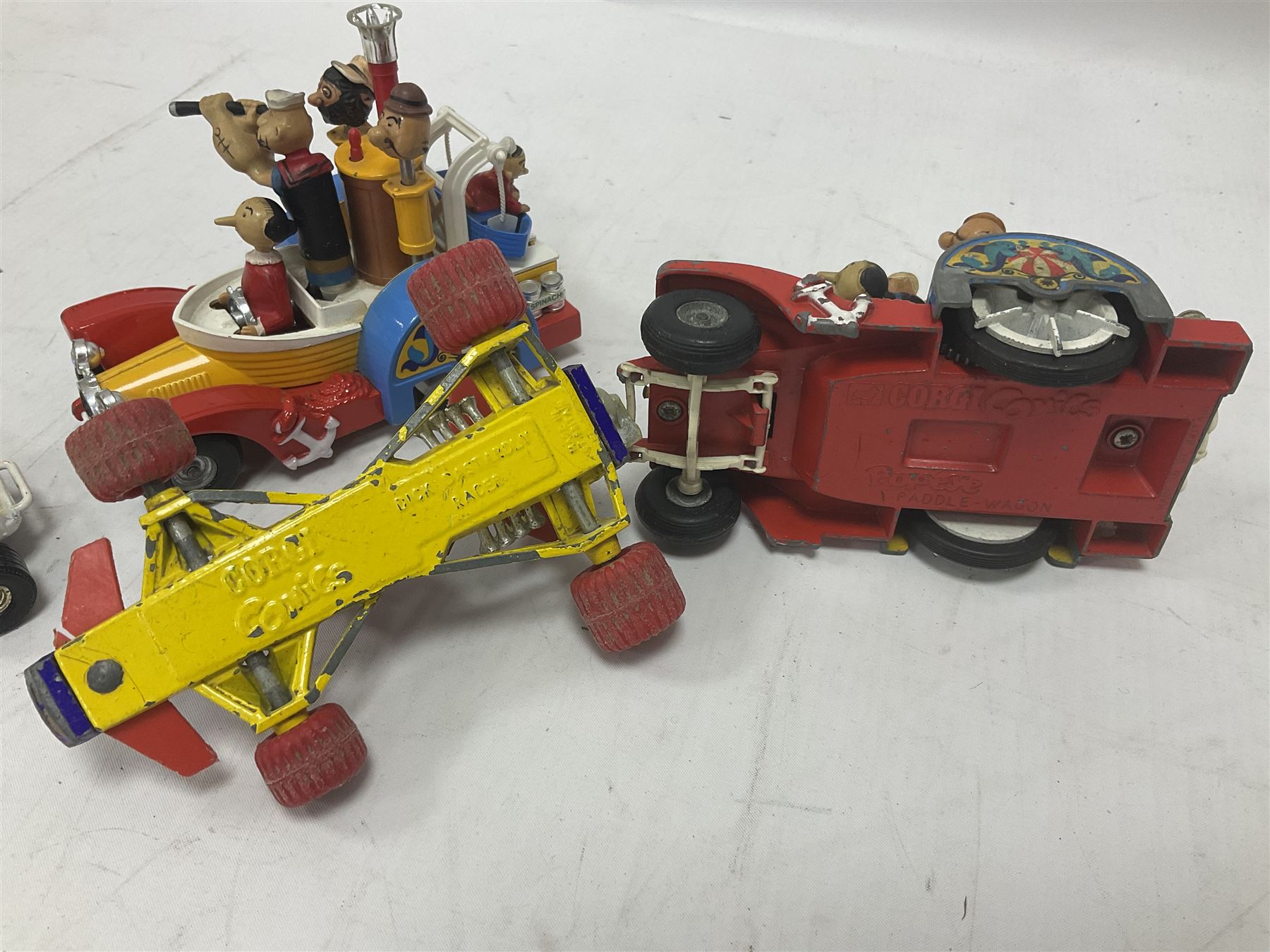 Corgi - ten unboxed and playworn TV/Film related die-cast models including three Popeye Paddle Wagons; Dick Dastardly; Magic Roundabout; Muppets; Batman Penguinmobile; and Basil Brush (10)
