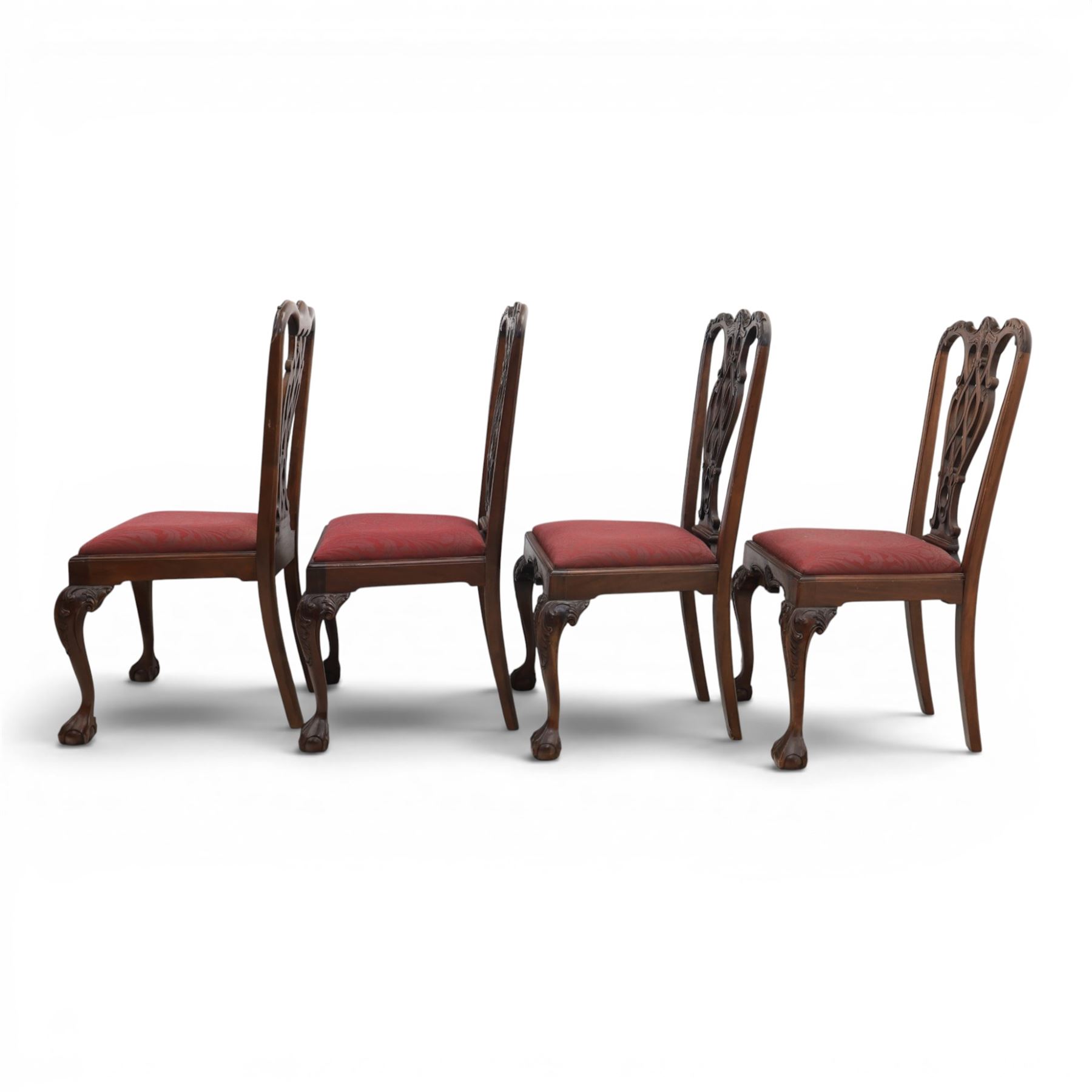 Chippendale design set of ten (8+2) mahogany dining chairs, serpentine cresting rails with carved detail over pierced ribbon-tied splats, red damask upholstered drop-in seats, on cabriole supports with acanthus carved knees and claw and ball feet