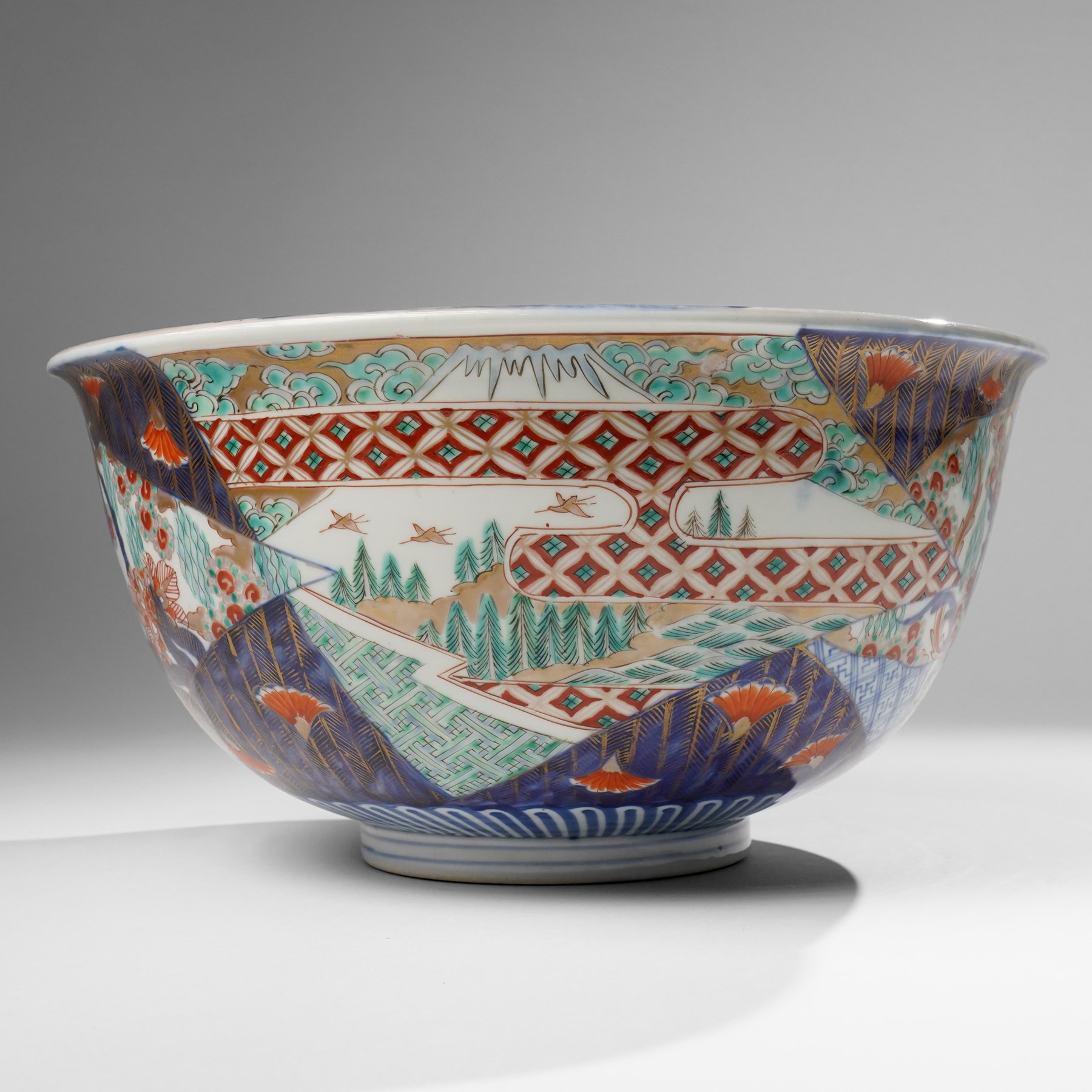 Japanese 19th century Imari bowl, painted profusely internally and externally with landscapes, flowers and traditional motifs, H16.5cm 