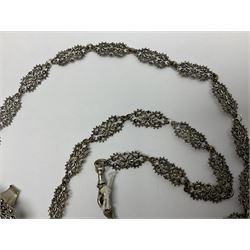 19th century continental silver plated chatelaine, the main body flanked with winged mythical beasts and central soldier slaying a dragon supporting three suspended items to include velvet lined small basket and long clasped filigree chain, together with a thimble