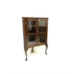 Oak glazed corner cupboard, two glazed doors, enclosing shelving, raised on acanthus carved cariole supports 