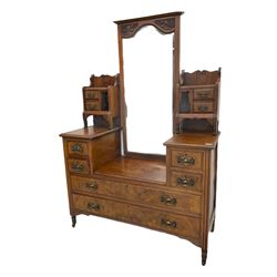 Late 19th century walnut dressing chest, drop centre with raised swing bevelled mirror and small trinket drawers, fitted with four small drawers and two long drawers