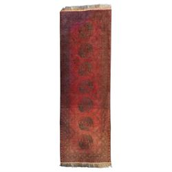 Antique Persian Bokhara red ground runner rug, repeating Gul pattern, surrounded by border...