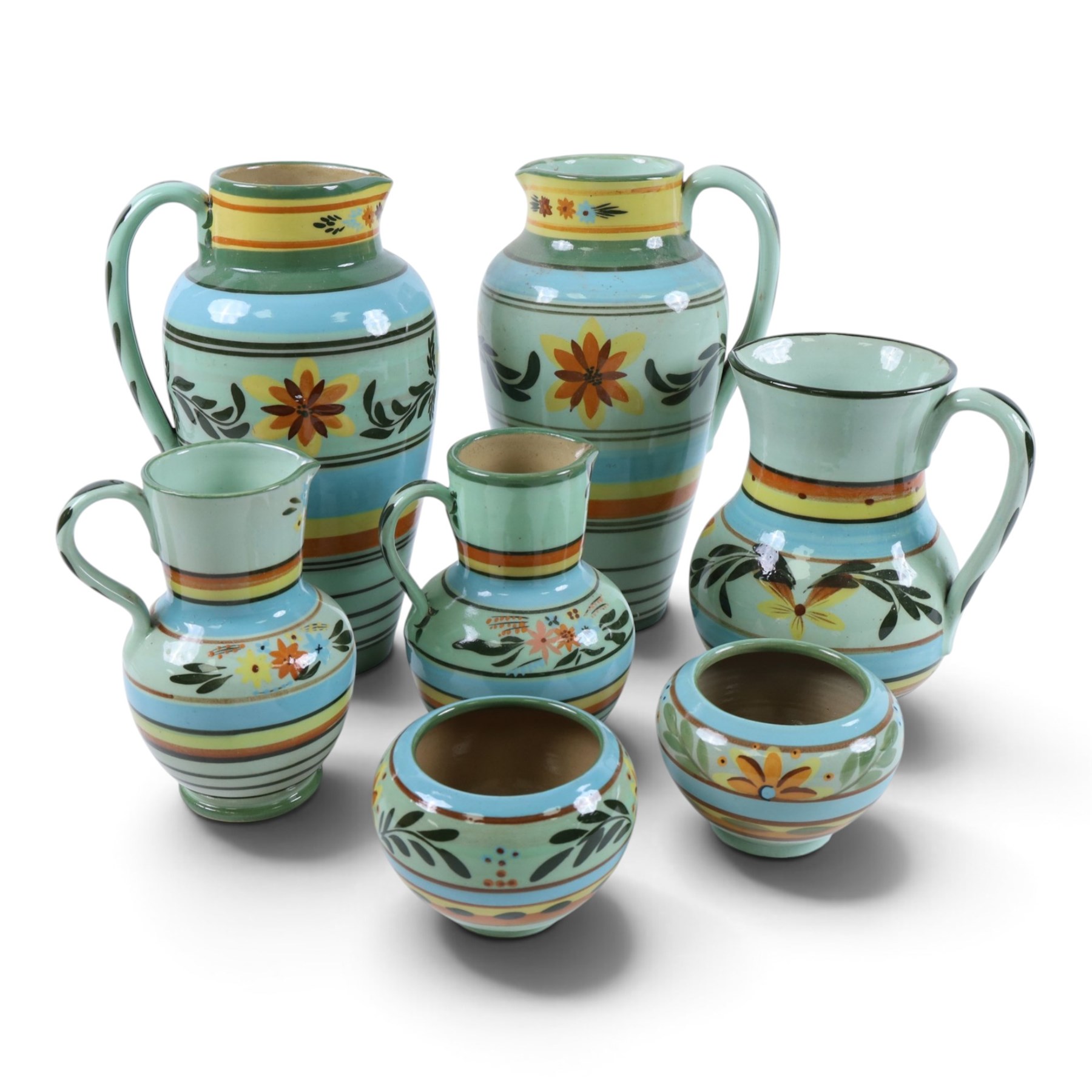 Hartrox Stoneware, comprising five jugs and two bowls, all with green, blue, yellow and oragne floral and abrstact decoration, with printed marks beneath, tallest H26cm