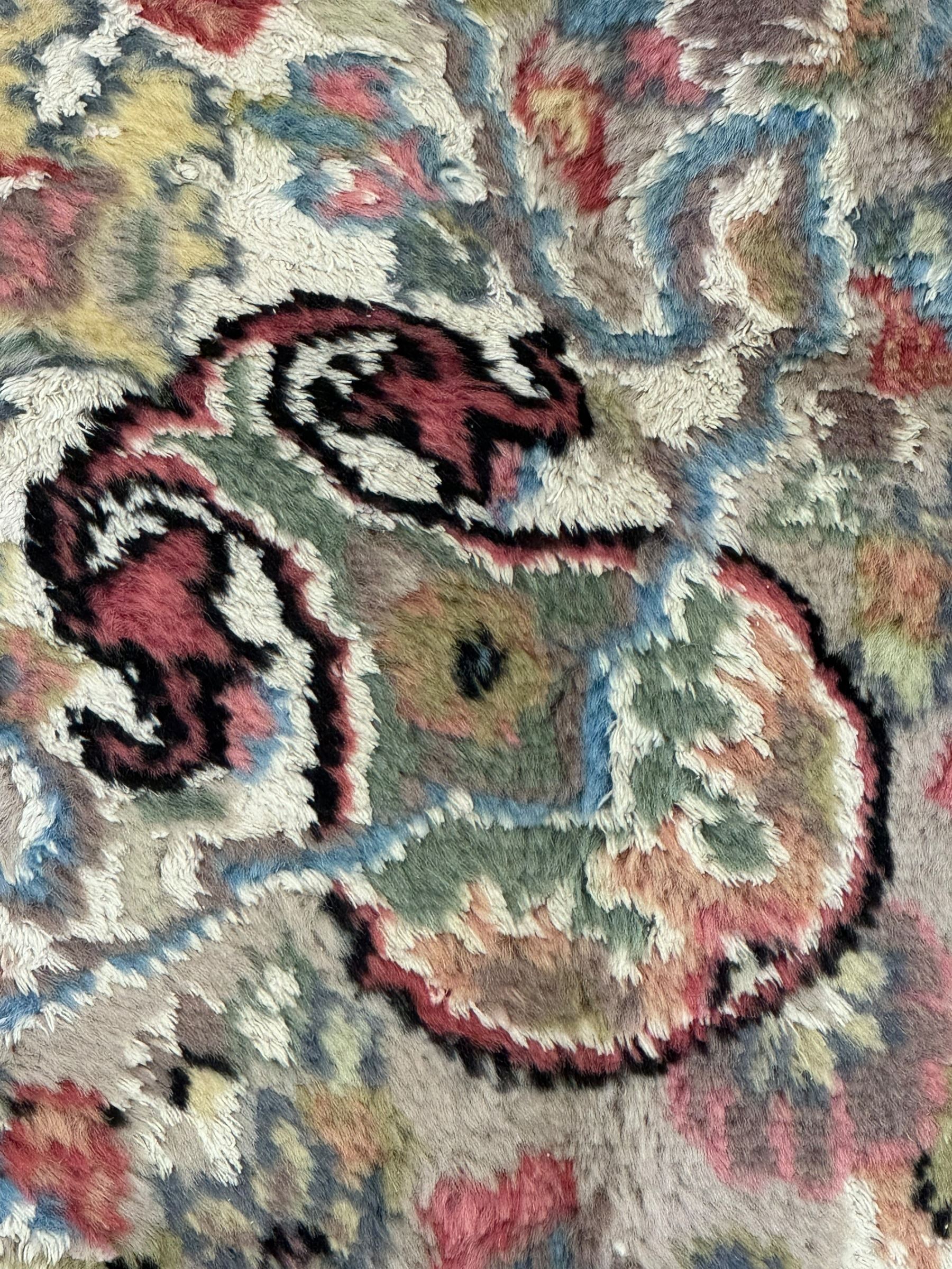 Persian design ivory ground rug, overall floral design with shaped central medallion, the main border decorated with trailing flower head pattern, within guard stipes 