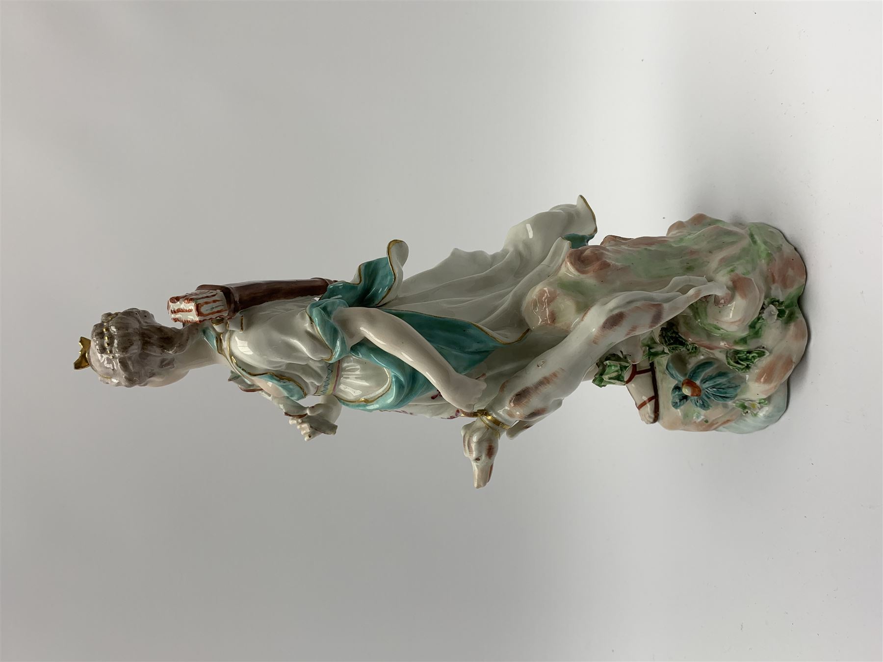 Mid 18th century Derby porcelain figure modelled as Dianna the Huntress, with quiver of arrows upon her back and dog by her side, upon a naturalistically modelled base, with patch marks beneath and collectors labels, H26cm