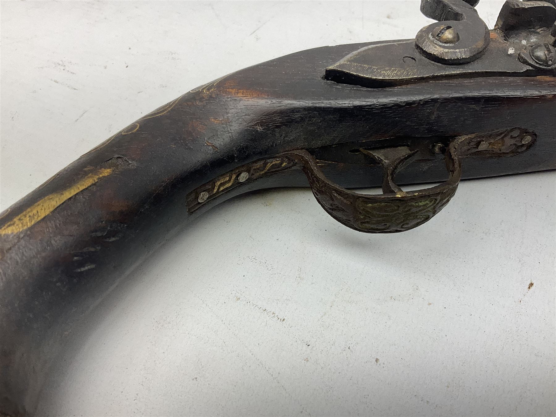 Reproduction flintlock pistol, the full walnut stock with brass filigree inlay and mounts and skull crusher butt L46cm; no visible proof marks FIREARMS CERTIFICATE REQUIRED OR RFD