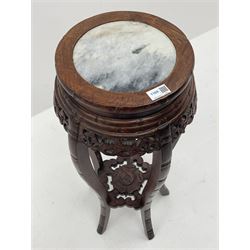 20th century carved padauk wood jardinière stand, circular top with inset marble, pierced and carved frieze, five shaped supports joined by flower head carved undertier 