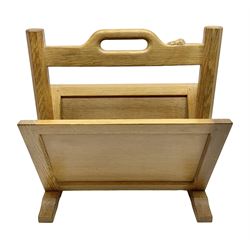 Mouseman - oak magazine rack, the top rail pierced with handle and carved with mouse signature, octagonal supports with two panelled and splayed sides, on sledge feet, by the workshop of Robert Thompson, Kilburn 