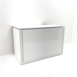  Gloss white cabinet, two doors enclosing five fitted shelves, (W111cm, H72cm, D61cm) and a two drawer bedside chest (W41cm, H56cm, D49cm)  