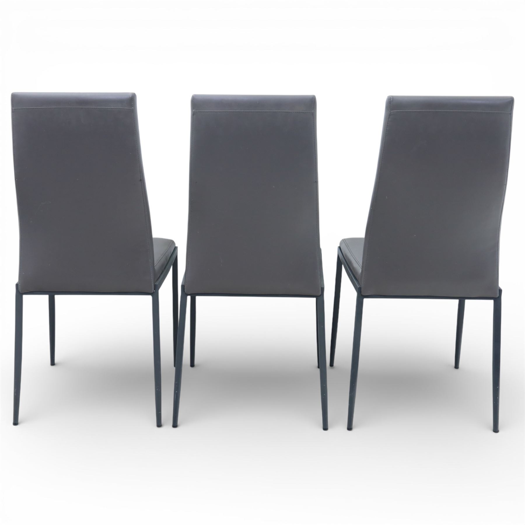 Modern composite marble effect dining table, rectangular top with simulated veining supported on a block pedestal base, accompanied by six matching dining chairs with padded seats and backs in grey upholstery on slim metal legs