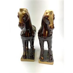 A pair of glazed pottery Tang style horses, each with impressed marks beneath, each approximately H25.5cm. 