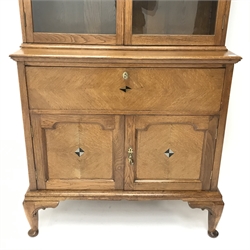  Early 20th century oak inlaid bureau bookcase projecting cornice, two glazed doors enclosing shelves above fall front unit, two cupboards, cabriole legs on pad feet, W115cm, H223cm, D49cm  