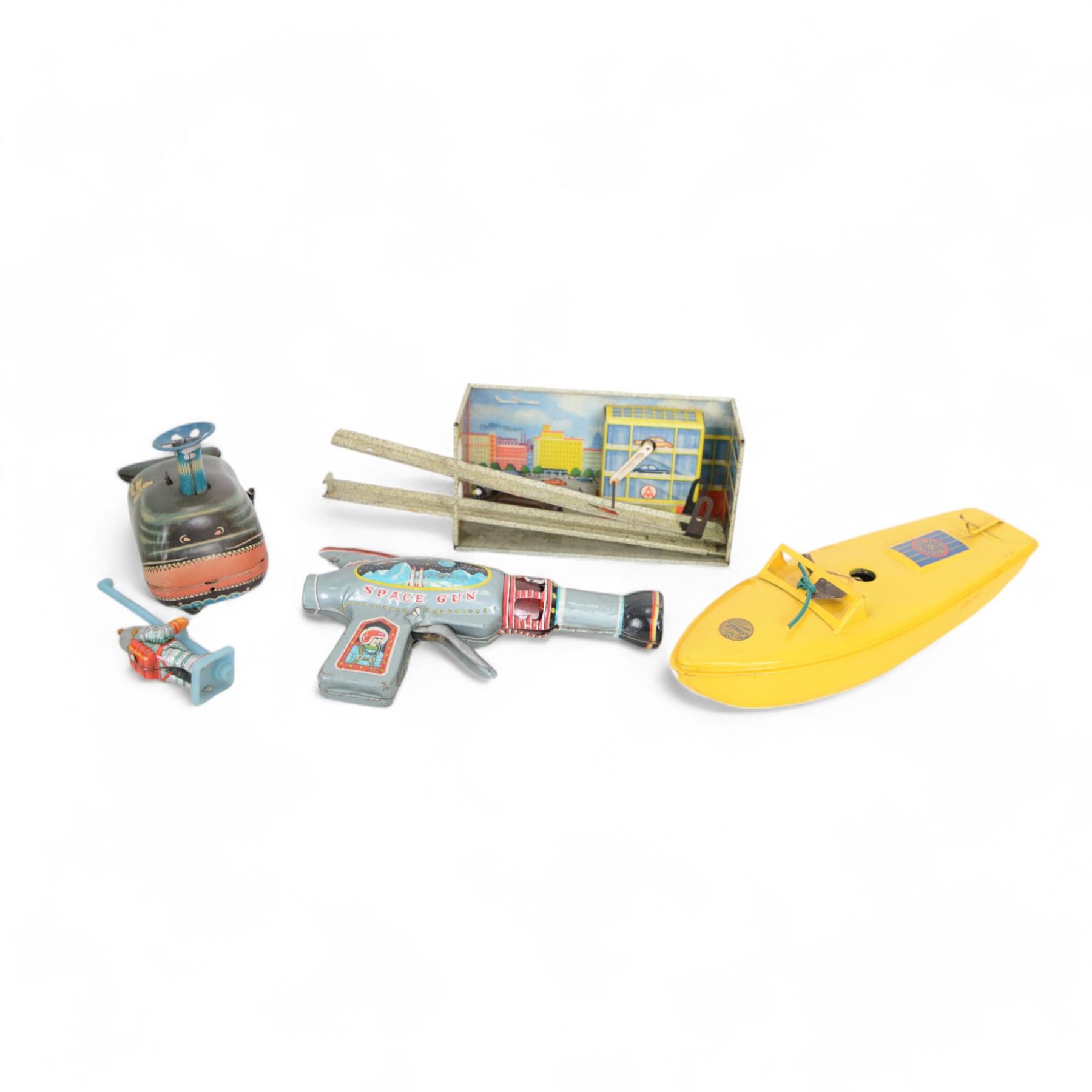 Sutcliffe Models Comet clockwork speedboat, boxed with key, together with a Russian tinplate garage toy, Japanese tin plate Billy The Ball Blowing Magic Whale, tin plate space gun etc 