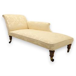 Victorian chaise longue upholstered in ivory damask fabric, padded back and armrest with rope piping, raised on turned feet with castors