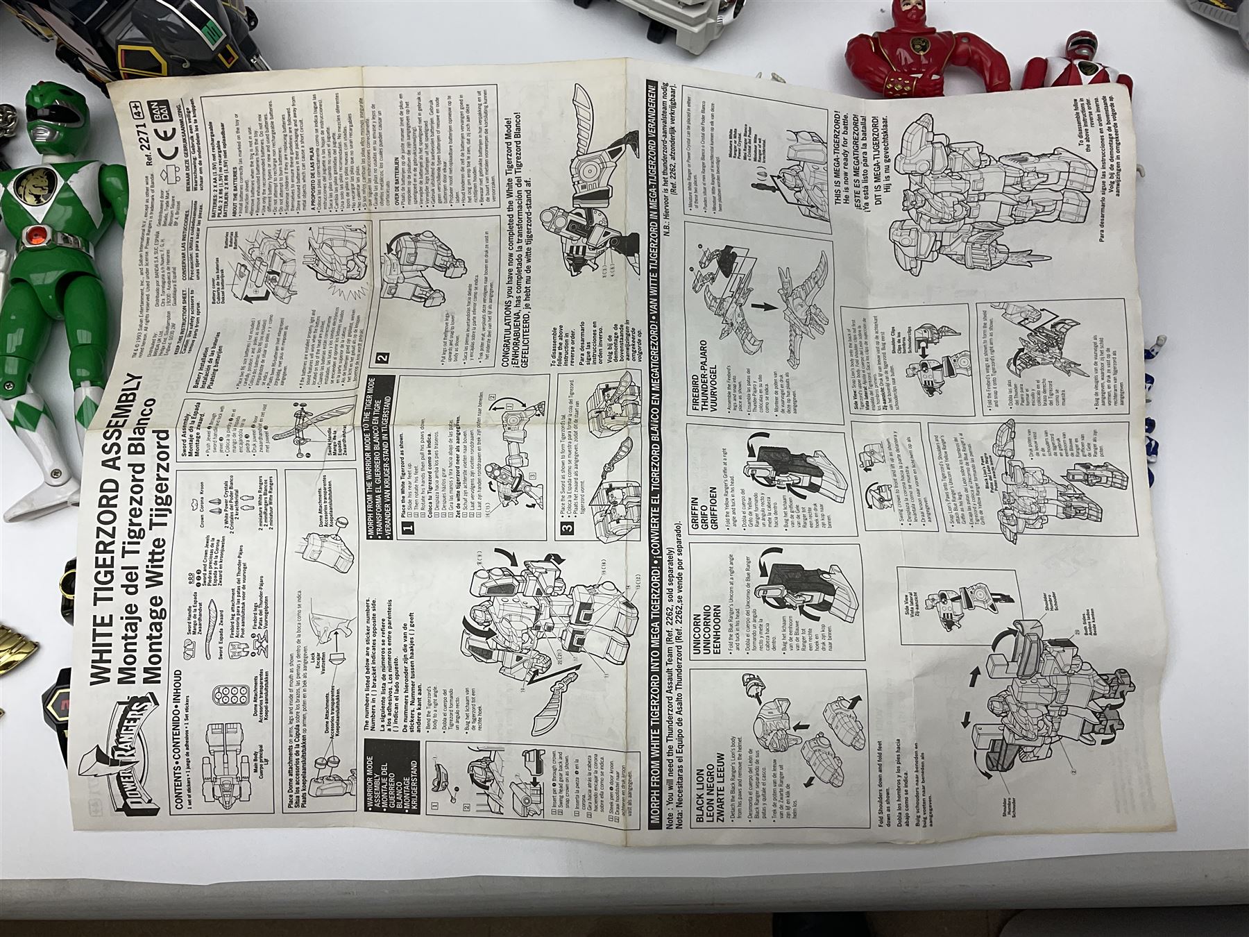 Collection of early 90s Mighty Morphin’ Power Rangers Zords, figures and accessories. Titanus the Carrier Zord, marked Bandai 1991; Green Dragonzord, incomplete; 1994 White Tigerzord with original instruction manual; 1993 Triceratops Dinozord, Mastodon Dinozord and Sabertooth Tiger Dinozord, Pterodactyl Dinozord, missing guns; with 1993 Power Morpher and original Power Coins, with further related figures, accessories and weapons