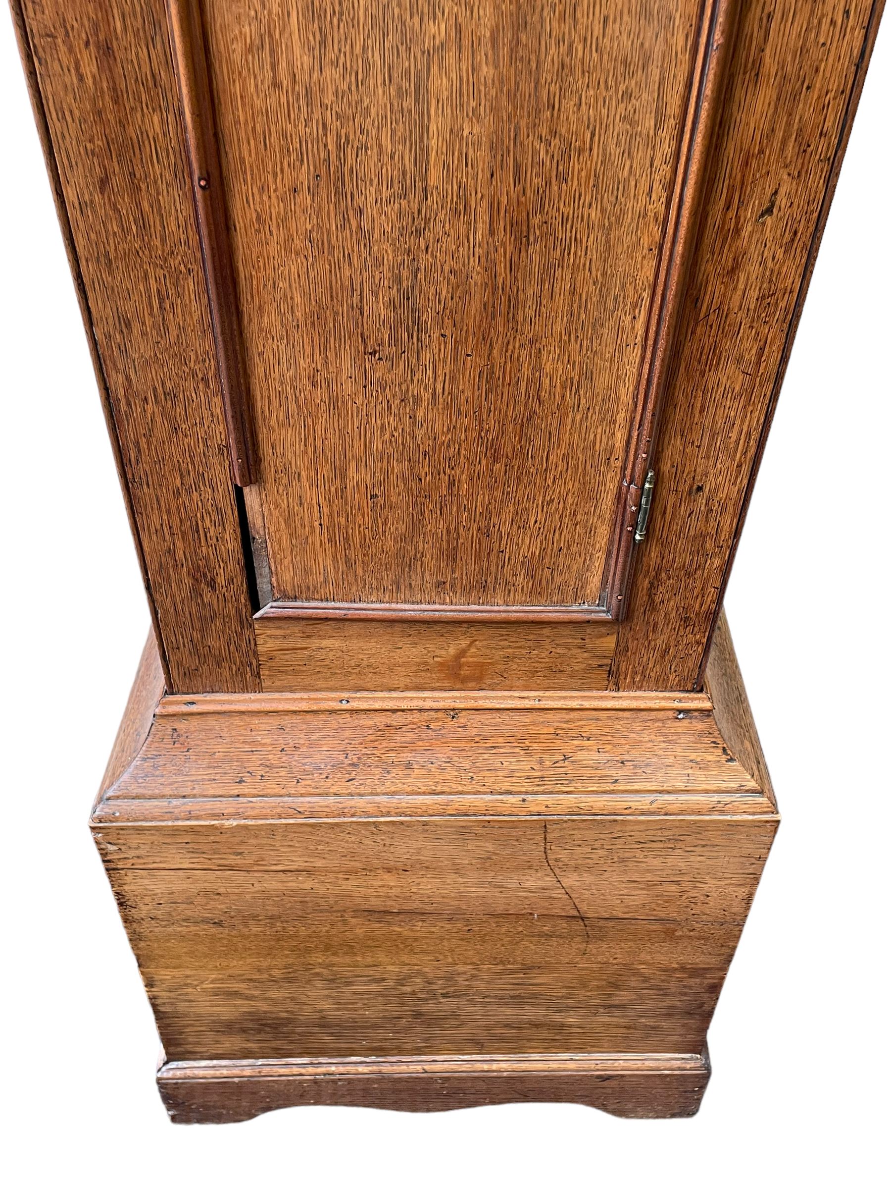 William Gostling of Diss  (Norfolk)-  Late 18th century 8-day oak longcase clock c1780-90, break arch top with scalloped cresting and three brass finials, glazed break arch hood door flanked by turned pilasters with brass capitals, trunk with a long trunk door and rounded top on a square plinth with an applied and shaped skirting, early painted Wilson of Birmingham dial with Roman numerals and five minute Arabic's, matching steel hands and second pointer, arched square ended calendar aperture with date disc behind, floral spandrels within gesso borders and a painted rocking automaton representing Mercury to the break arch, dial pinned via a false plate to a weight driven rack striking movement with a recoil anchor escapement, striking the hours on a cast bell. With pendulum weights and key. 
William Gostling (II) is recorded as working in Diss from 1774 to 1797, succeeded by widow Anne and son George . The dial of this clock is illustrated and discussed in detail in M.F. Tennants book 