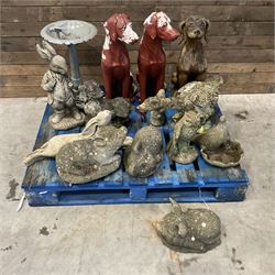 Various cast stone and composite garden ornaments, to include Peter Rabbit, goose, pigs, dogs, dog with wheelbarrow, painted metal bird bath and other, on two pallets
