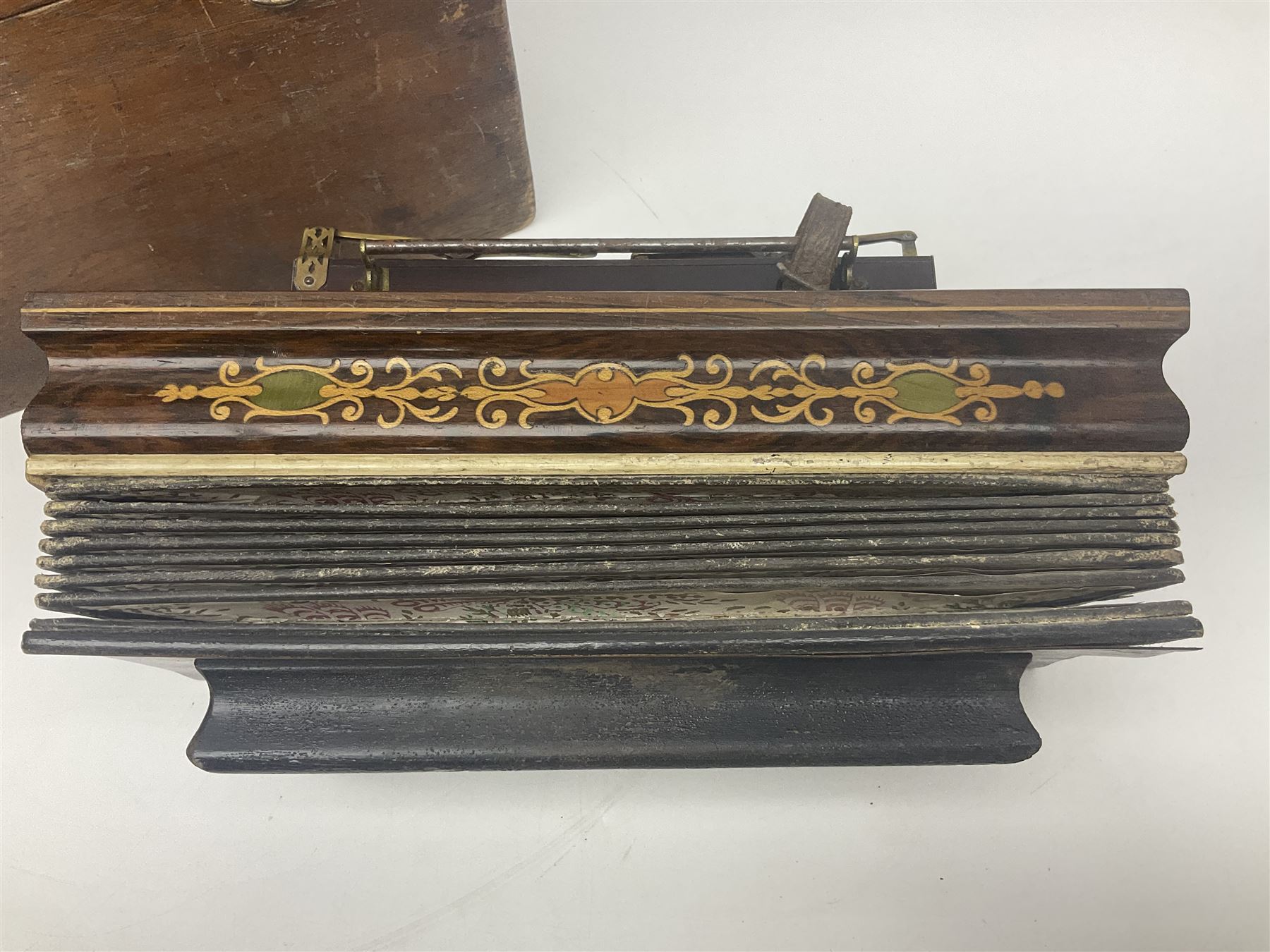 19th Century inlaid rosewood Flutina accordion, stamped Busson of Paris, having sixteen mother of pearl keys and six fold floral decorated bellows L30cm; in baize lined mahogany box