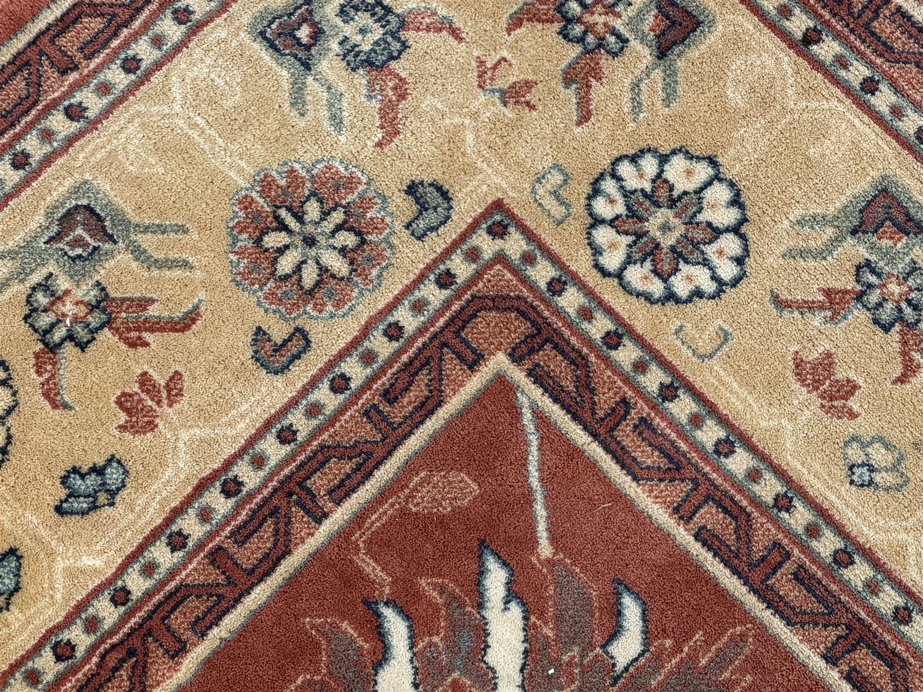 Late 20th century Royal Keshan 'Agra' hand-knotted wool rug, terracotta ground with central floral medallion and scrolling vines, enclosed by a cream border with repeating floral motifs