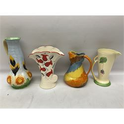 Group of Art Deco ceramics, comprising Wadeheath jug painted in spiralled bands of blue, orange, yellow and brown, shape no. 707784, Royal Doulton Caprice pattern twin handled bowl, no. D5358, Arthur Wood wall pocket of typical stylised fan form with painted floral decoration, Arthur Wood vase of cornucopia form with red and grey floral decoration, Wadeheath jug of ribbed form with stylised handle, and two Hancock's Ivory Ware jugs, tallest example H26cm