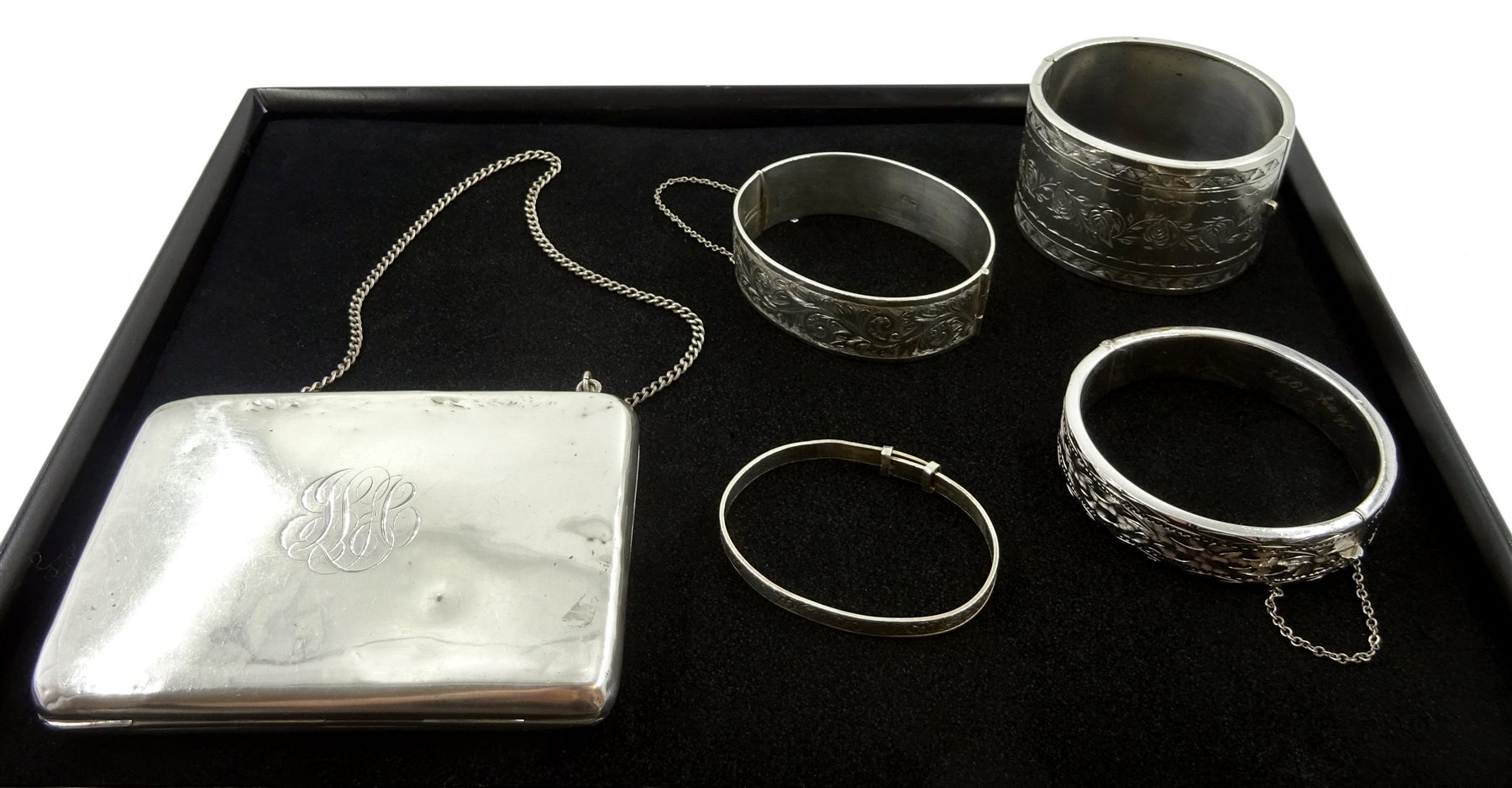 Silver bangle by Henry Griffith & Sons Ltd, Birmingham 1957, three other silver bangles stamped or hallmarked and a silver purse by Ellis Bros, stamped sterling