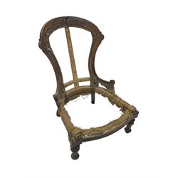 Late Victorian walnut and beech framed nursing chair, with carved scroll decoration, on turned supports 