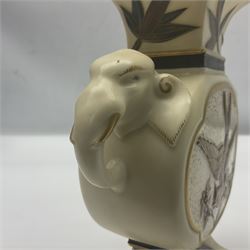 19th century Royal Worcester aesthetic movement vase in blush ivory, the rectangular neck above twin pierced elephant mask handles with opposing panels decorated with a bird and floral spray raised on a spreading rectangular foot, with puce mark beneath 