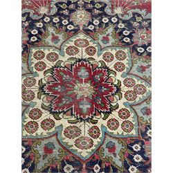 Persian red ground rug, large floral medallion and matching spandrels, decorated with stylised flower heads