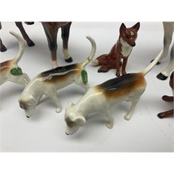Beswick hunting group, comprising huntswoman on dappled grey horse no 1730, huntsman on bay horse no 1501, two fox figures no 1440 and 1748, and four fox hounds, all with printed marks beneath (8)