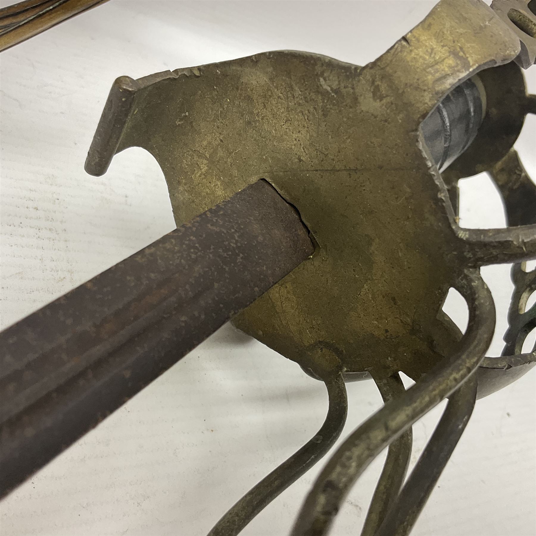 Victorian 1845 pattern infantry officer's sword the 82cm sharpened fullered steel blade with traces of decoration, brass gothic hilt incorporating Victorian cypher, folding back guard, stepped pommel with acanthus leaf backstrap and wire-bound wooden grip with traces of original fish skin covering L96cm overall; together with a reproduction Scottish style basket hilted sword; both lacking scabbard (2)