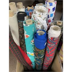 Haberdashery Shop Stock: Various rolls of fabric including a large roll of striped lining fabric, metallic printed stage satin, abstract and geometric patterns, children's and festive fabric, Paisley and others (qty) in two boxes 