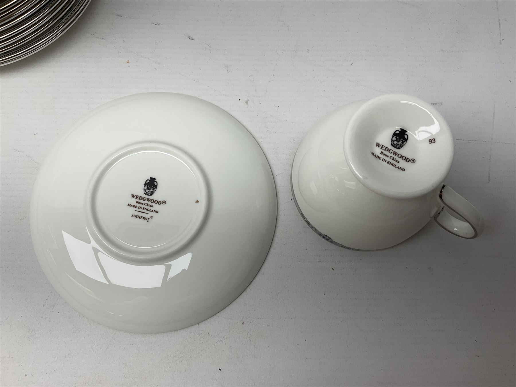 Wedgwood Amherst pattern part tea service, comprising eight cups and saucer, sixteen dessert plates, milk jug, covered sucrier, together with matching platter and two open serving dishes