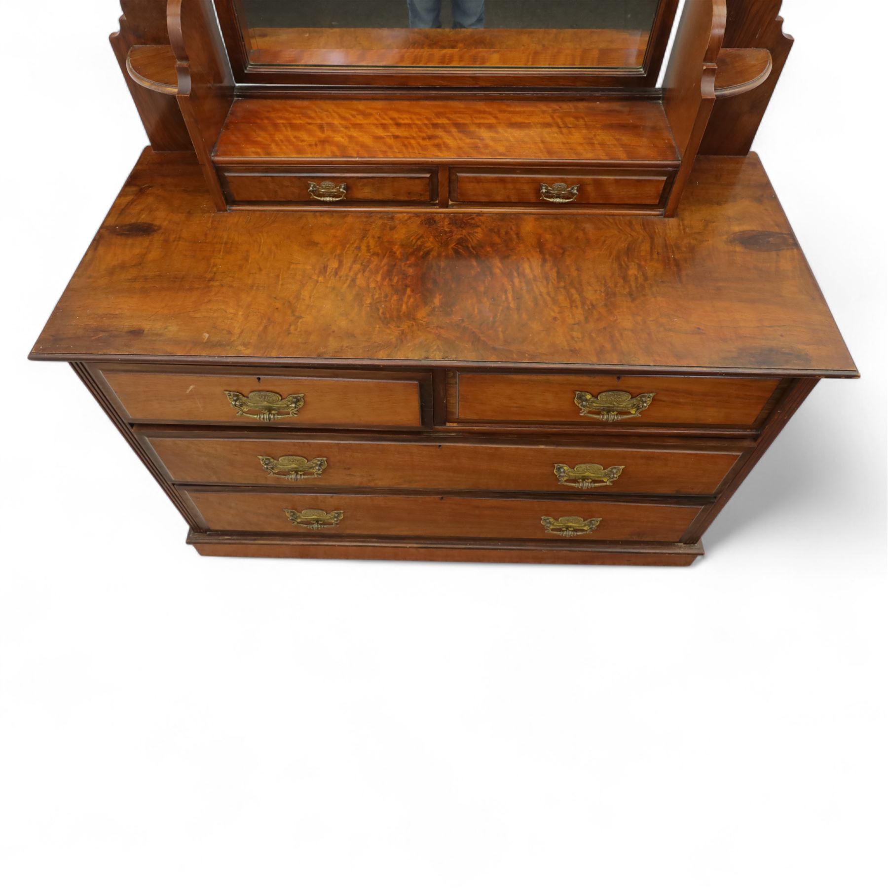 Edwardian walnut dressing chest, rectangular top surmounted by a mirror frame with shaped pediment on swing supports above two short frieze drawers over two short and three long graduated drawers fitted with brass foliate handles, raised on a plinth base