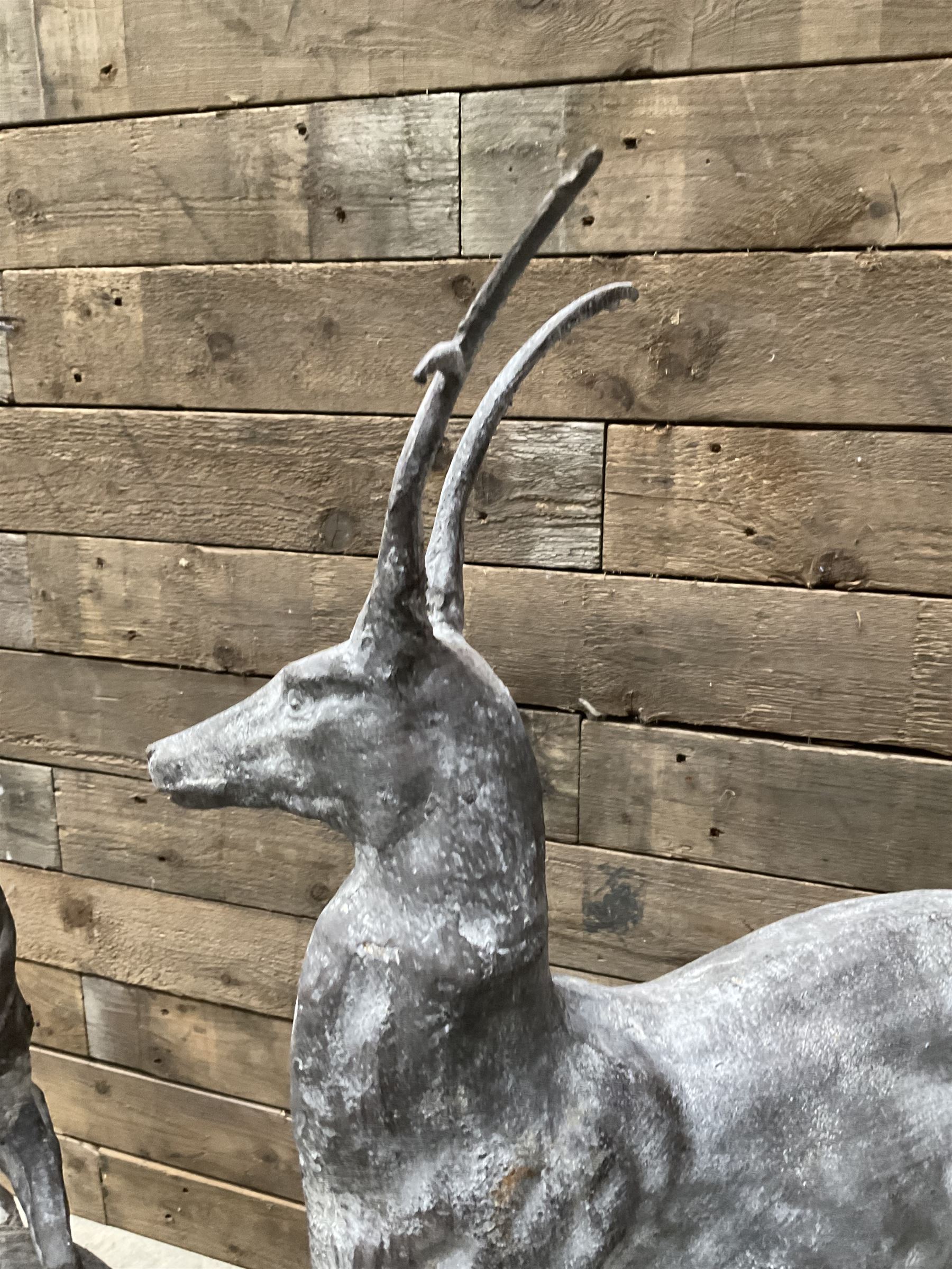 Pair of cast iron garden Stag figures or gate finials, raised on spherical ribbed base 