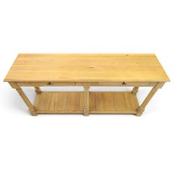 Neptune - 'Edinburgh' limed oak console table, with two
soft close drawers raised on ring-turned column supports,
with a pot shelf raised on square feet