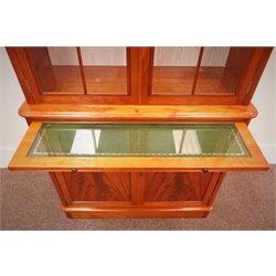  Charles Barr quality reproduction mahogany bookcase display cabinet on cupboard, swan neck pediment, glazed doors enclosing shelves above slide and two cupboard doors on plinth base, W101cm, H233cm, D41cm  