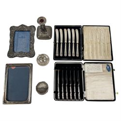Two sets of cased silver handled tea knives, two silver mounted photo frames, silver mount...