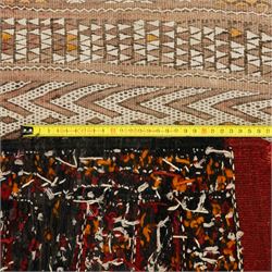 Berber style mid 20th century flat-weave kilim, woven is alternating horizontal bands of hooked lozenges, diamonds, and chevron motifs in a terracotta, ochre, ivory, and brown palette, framed by narrow geometric borders  