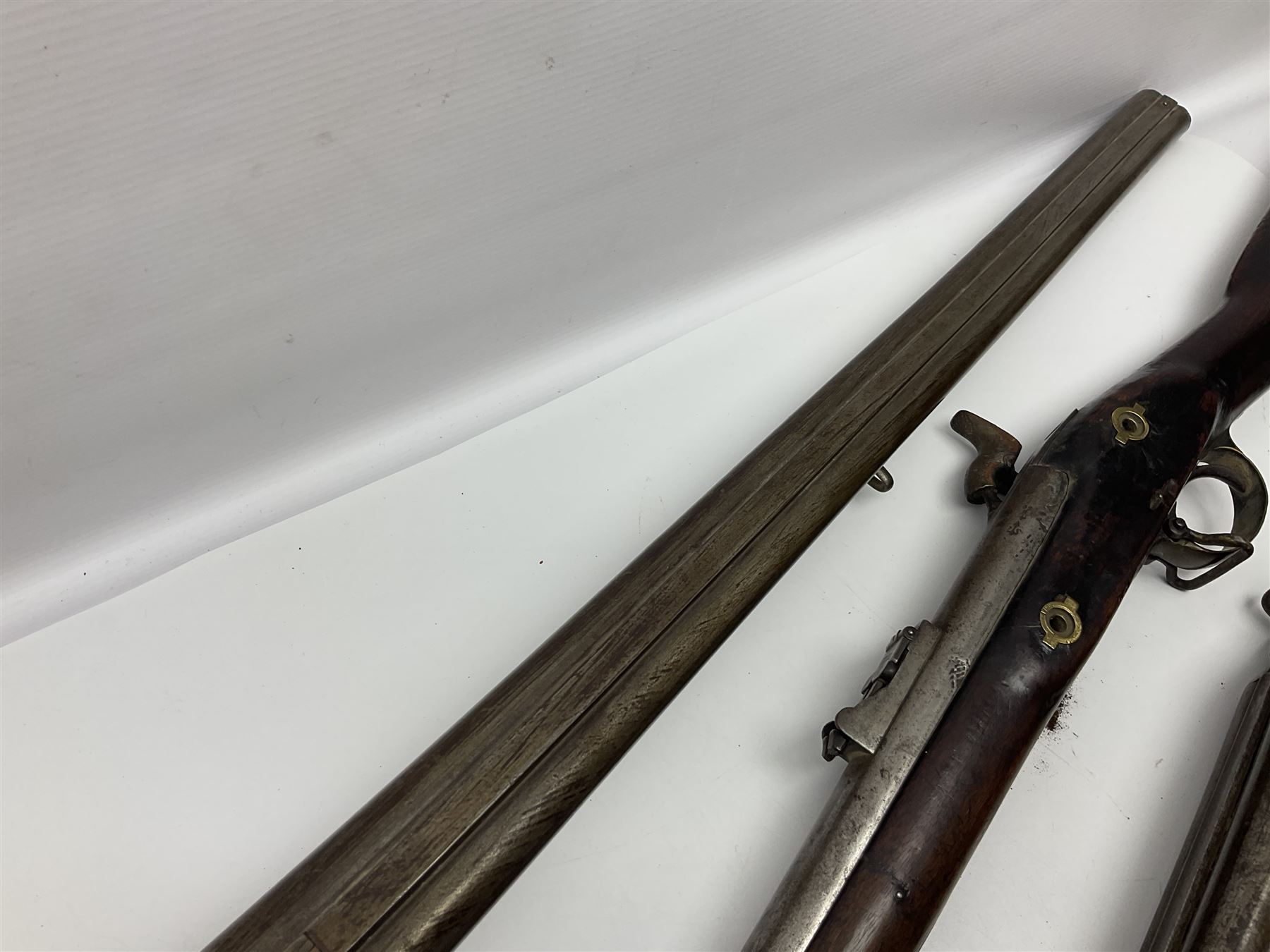 19th century Indian .577 Enfield muzzle loading rifle, proofed for 26-bore, the 98.5cm barrel with three barrel bands and later ram rod L140cm overall; 19th century Belgian side-by-side double barrel percussion shotgun, approximately 20-bore, with 74cm barrels and studded walnut stock, lock plate marked 'Liege 1868' and 'V. Gulikers-Maquinay' L117cm overall; and another side-by-side double barrel shotgun by Smythe with underlever opening (3)