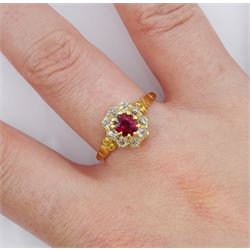 Early 20th century 18ct gold oval cut ruby and old cut diamond cluster ring, stamped, ruby approx 0.45 carat, total diamond weight approx 0.35 carat