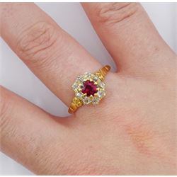 Early 20th century 18ct gold oval cut ruby and old cut diamond cluster ring, stamped, ruby approx 0.45 carat, total diamond weight approx 0.35 carat