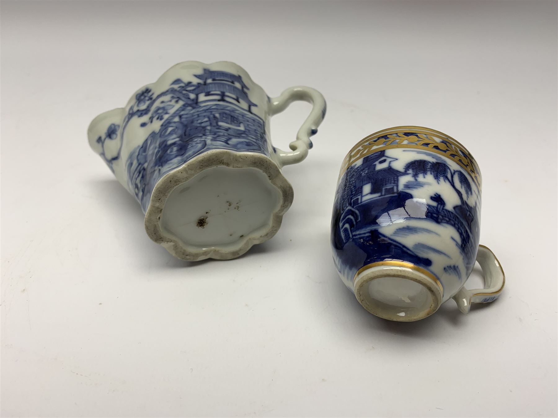 18th century Chinese blue and white porcelain plate, of octagonal form decorated with a riverside scene with pagodas, fence, and trees, within lattice and key fret detailed border, D22.5cm, together with a late 18th/early 19th century blue and white cream boat of English shape, H8.5cm, and an early 19th century Chinese blue and white coffee cup, H6cm, both decorated in riverside scenes 