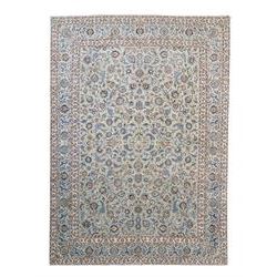 Central Persian Kashan hand-knotted carpet, pale blue field decorated with an all-over scrolling floral vine design incorporating stylized palmettes, rosettes and foliate sprays enclosed by a conforming floral vine border between multiple guard stripes, with cotton fringe ends 