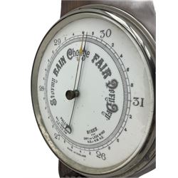 An English carved oak cased aneroid barometer with an 8'' porcelain dial, measuring barometric pressure from 26 to 31.9 inches, weather predictions written in gothic capitals and lower-case script, with a steel indicating hand and brass recording hand within a chrome bezel with a flat bevelled glass, with a spirit thermometer recording the temperature in degrees Fahrenheit and Celsius.



