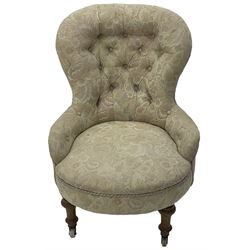 Victorian walnut framed nursing chair, upholstered in buttoned floral pattern fabric, on turned front feet 